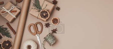 Photo for Christmas background with gift boxes and kraft wrapping paper. Xmas celebration, preparation for winter holidays. Festive mockup, top view, flatlay - Royalty Free Image