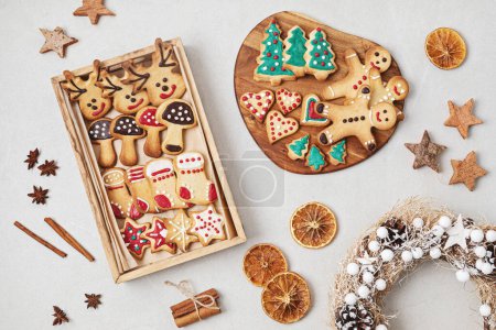 Photo for Traditionals Christmas homemade cookies preparation. Winter holidays celebration. Xmas biscuits with icing for diy gifts - Royalty Free Image