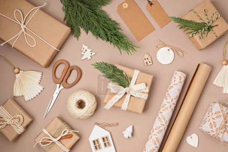 Photo for Christmas background with gift boxes and kraft wrapping paper. Xmas celebration, preparation for winter holidays. Festive mockup, top view, flatlay - Royalty Free Image