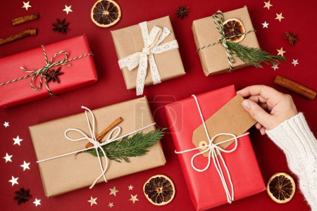 Photo for Christmas background with gift boxes. Xmas celebration, preparation for winter holidays, secret Santa concept. Festive mockup, top view, flat lay - Royalty Free Image