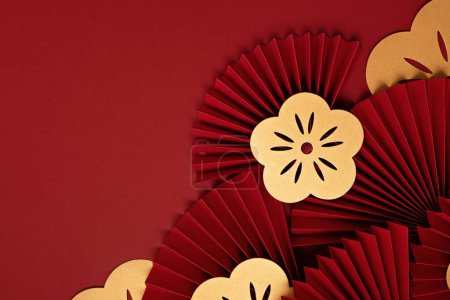 Foto de Chinese new year festival or wedding decoration over red background. Traditional lunar new year paper fans. Flat lay, top view, banner - Imagen libre de derechos
