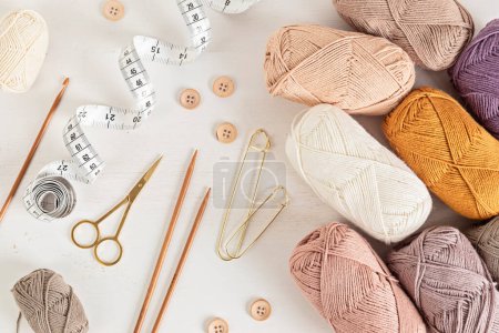 Photo for Craft knitting hobby background with yarn in natural colors. Recomforting hobby to reduce stress for cold fall and winter weather. Mock up, copy space, top view - Royalty Free Image