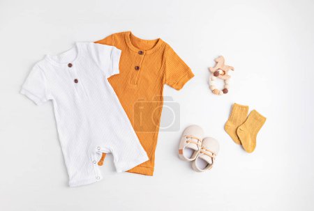 Photo for Gender neutral baby garment and accessories. Organic cotton clothes, newborn fashion, branding, small business idea. Flat lay, top view - Royalty Free Image