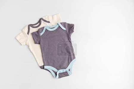 Photo for Gender neutral baby bodysuits mockup. Organic cotton clothes, newborn fashion, branding, small business idea. Flat lay, top view - Royalty Free Image