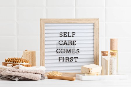 Photo for Bathroom styling and organization. Letter board with text Self care comes first. Organic lifestyle and skin care products. - Royalty Free Image
