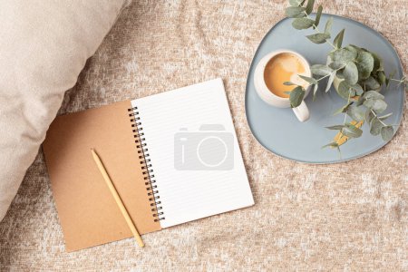Téléchargez les photos : Mockup of notebook and coffee cup on beige plaid background, with copy space for text. Flat lay, top view photo mock up. - en image libre de droit