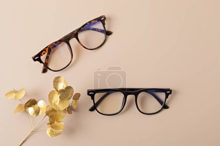 Photo for Stylish eyeglasses over pastel background. Optical store, glasses selection, eye test, vision examination at optician, fashion accessories concept. Top view, flat lay - Royalty Free Image