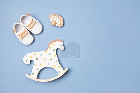 Photo for Gender neutral baby shoes, rocking horse and teether. Organic newborn fashion, branding, small business idea - Royalty Free Image