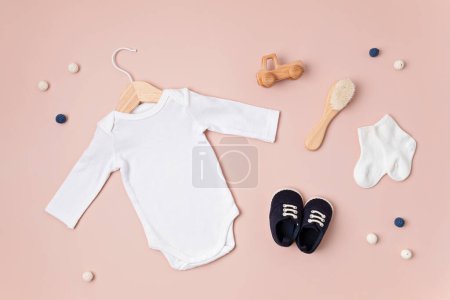 Photo for Mockup of white infant bodysuit made of organic cotton with eco friendly baby accessories. Onesie template for brand, logo, advertising. Flat lay, top view - Royalty Free Image