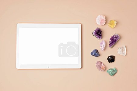 Photo for Healing chakra crystals and tablet mockup. Online application for rituals with gemstones for career, wellness, business, relaxation, mental health, spiritual practices. Energetical power concept - Royalty Free Image