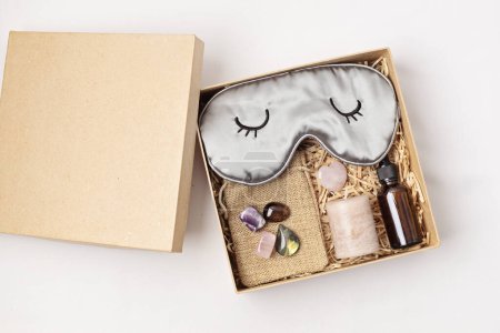 Gift box for improving sleep quality with gemstones. Healing chakra crystals, candle, essential oil and sleeping mask. Care package for natural treatment of insomnia