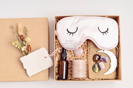 Gift box for improving sleep quality with gemstones. Healing chakra crystals, candle, essential oil and sleeping mask. Care package for natural treatment of insomnia