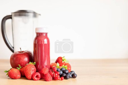 Photo for Healthy fresh red fruit smoothie with assorted ingredients of various berries. Superfood detox and diet concept. Top view, flat lay - Royalty Free Image