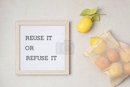 Photo for Reusable mesh bag with fruits and letterboard with text reuse it or refuse it. Zero waste sustainable lifestyle. Eco friendly habits concept - Royalty Free Image