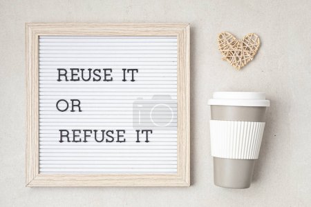 Photo for Reusable coffee goblet and letterboard with text reuse it or refuse it. Zero waste sustainable lifestyle. Eco friendly habits for take away coffee - Royalty Free Image
