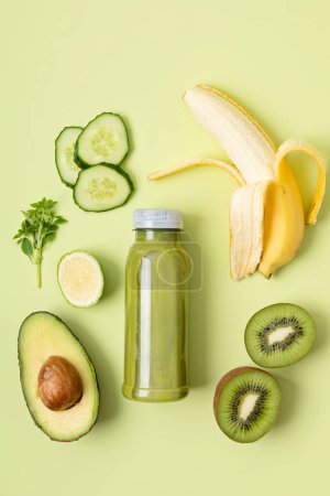 Photo for Healthy fresh avocado, kiwi, banana and cucumber green smoothie with assorted ingredients. Superfood detox and diet concept. Top view, flat lay - Royalty Free Image