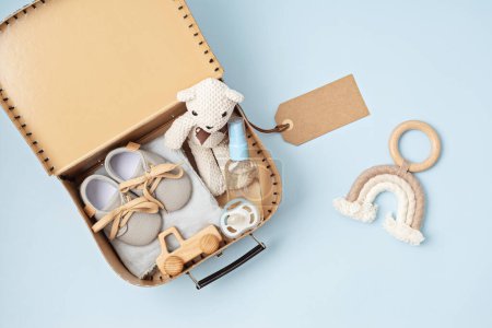 Photo for Gift basket with gender neutral baby garment and accessories. Care box of organic newborn booties, fashion, branding, small business idea. Flat lay, top view - Royalty Free Image