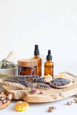 Photo for Botanical blends, herbs, essencial oils for naturopathy. Natural remedy, herbal medicine, blends for bath and tea on wooden table background - Royalty Free Image