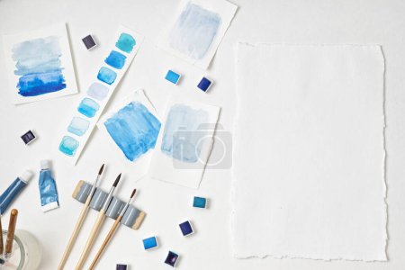 Photo for Artist painting watercolor palettes in blue pastel with brushes. Craft artistic background. Recomforting, destressing hobby, art therapy - Royalty Free Image