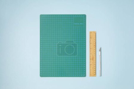 Photo for Top view over paper cut tools, ruler, cutter, cutting mat for paper cutting. DIY trendy project concept. Flat lay - Royalty Free Image