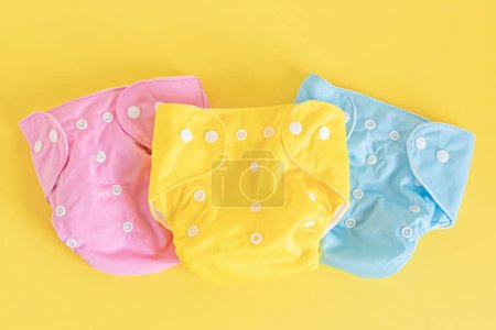 Photo for Flat lay with reusable cloth baby diapers. Eco friendly nappies on pastel background. Sustainable lifestyle, zero waste idea - Royalty Free Image