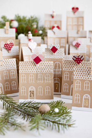 Photo for Handmade advent calendar. Houses shaped carton gift boxes. Eco friendly Christmas gifts diy concept - Royalty Free Image
