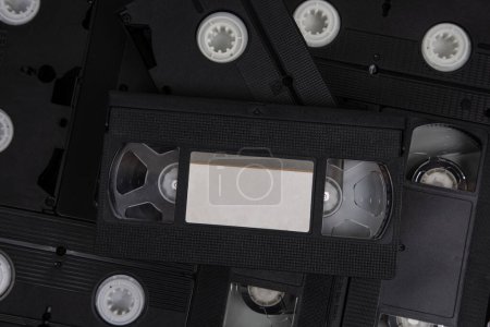 Videotape with blank tags. Pile of VHS video cassettes. Vintage media. Isolate on a white background.