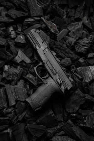 Photo for Air gun. Modern pneumatic weapon for air soft, sports and entertainment. A dummy, a copy of a real pistol.  Dark charcoal background. - Royalty Free Image
