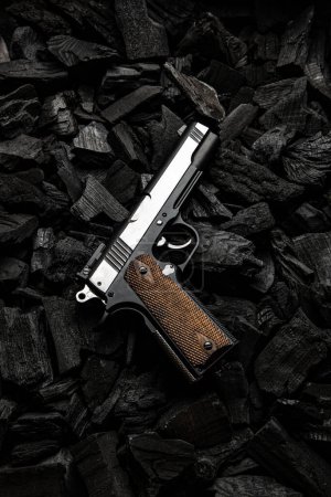Photo for Air gun. Modern pneumatic weapon for air soft, sports and entertainment. A dummy, a copy of a real pistol.  Dark charcoal background. - Royalty Free Image