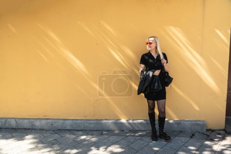 Young beautiful strong independent rebel blonde woman Punk music and style fan posing. Confident Punk-Rock youth culture street style concept. Cool attitude bee different concept