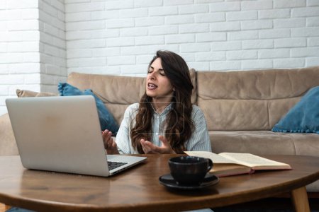 Young freelance graphic designer woman has a problem with attention deficit disorder (ADHD), she can't start work on new project. Female loses concentration can't work from home on laptop computer