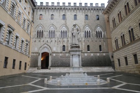 Photo for Siena, Italy - 22 Nov, 2022: Piazza Salimbeni, Banca Monte dei Paschi di Siena, and the state of Sallustio Bandini - Royalty Free Image