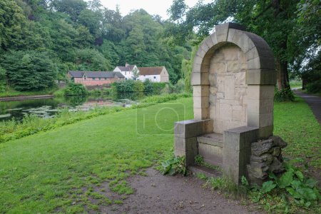 Photo for Durham, UK - 12 July, 2023: Stone Gargoyle Chair on the banks of the River Wear, Durham, England - Royalty Free Image