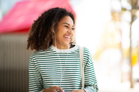 Photo for Portrait happy young woman smiling young woman with mobile phone and earphones - Royalty Free Image