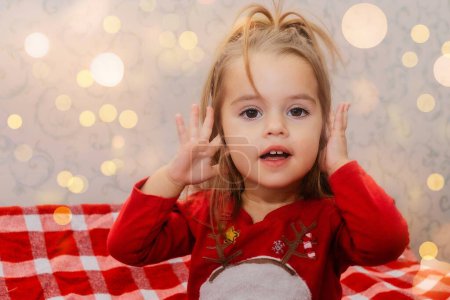 Photo for Sweet little girl with beautiful eyes. Beautiful little child celebrates Christmas. Advertising of childrens goods. - Royalty Free Image