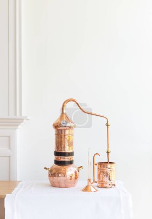 Distillation of lavender essential oil. Copper alambic in a Scandinavian interior