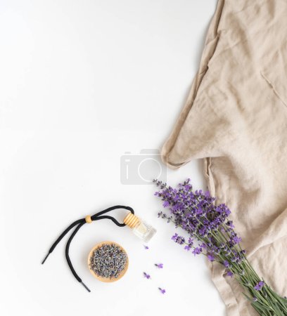 Amber bottle of lavender essential oil. Flat lay concept skin care. Light background with lavend flower