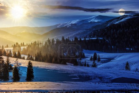 Foto de Bosque de abetos en un prado lleno de nieve en las montañas con sol y luna en el crepúsculo. concepto de cambio de día y de noche. paisaje de campo misterioso en la luz de la mañana - Imagen libre de derechos