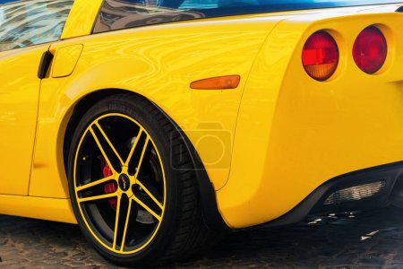 Photo for Uzhgorod, ukraine - 31 oct 2021: close-up of a yellow chevrolet corvette car. back wheel and rear tail lights - Royalty Free Image