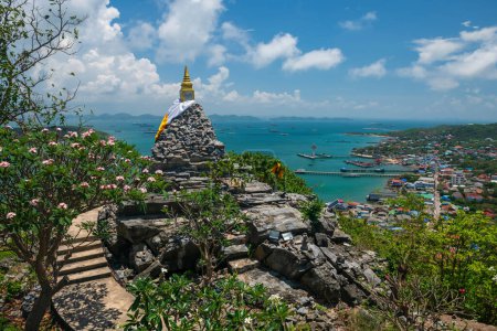 Golden pagoda on hill summit with beautiful sea and city view at Juthathit temple, Sichang island, Siracha, Chonburi, Thailand. Famous travel destination in tropical country, Siam.