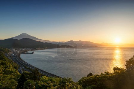 Photo for Mt. Fuji seen from Satta Toge pass at sunrise with reflection on sea, Shimizu, Shizuoka, Japan. Famous photography top view spot for tourist people. - Royalty Free Image