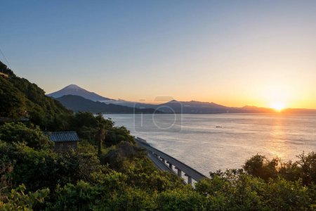 Photo for Mount Fuji and expressway seen from Satta Toge pass at sunrise with reflection on sea, Shimizu, Shizuoka, Japan. Famous photography top view spot for tourist people. - Royalty Free Image