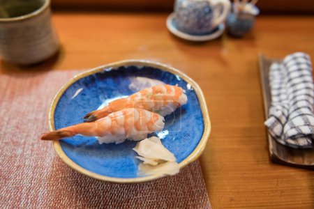 Ebi nigiri or shrimp sushi on wooden table of Japanese restaurant in Karatsu, Saga, Japan.