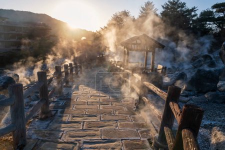 Mount Unzen Hell valley Jigoku and hot springs at sunset with heavy gas steam by Shimabara city, Nagasaki, Kyushu, Japan. Hot water, gases and steam spout out of the earth