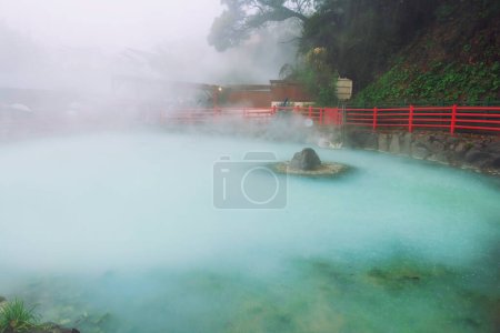 Kamado Jigoku blue hot spring with heavy rain and steam in Beppu, Oita, Japan. Town is famous for its onsen hot springs and 8 major geothermal hot spots, 8 hells of Beppu.