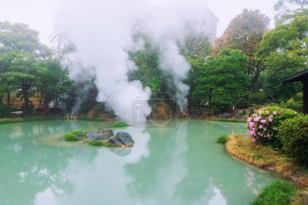 Shiraike jigoku white pond hell with heavy steam and reflection at spring, Beppu, Oita, Kyushu, Japan. Town is famous for its onsen hot springs and 8 major geothermal hot spots, 8 hells of Beppu.