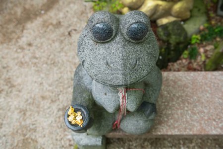 Top view of cute frog statue begging for money at Nyoirinji Temple, Ogori, Fukuoka, Japan. Here is famed for toad statue referred to as Kaeru dera, while the formal name is Seieizan Nyoirin-ji.