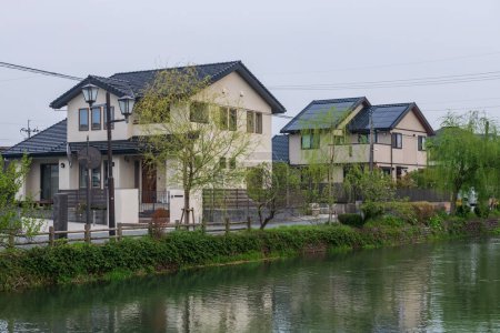 Japanese modern house in village along Yanagawa canal in morning, Fukuoka, Khushu, Japan. Tranquil city landscape.