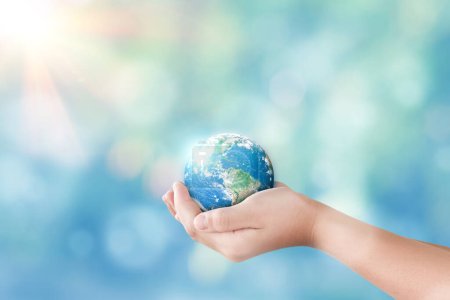 Hands holding global on blurred nature background. World day for water and sustain for earth concept. Elements of this image furnished by NASA