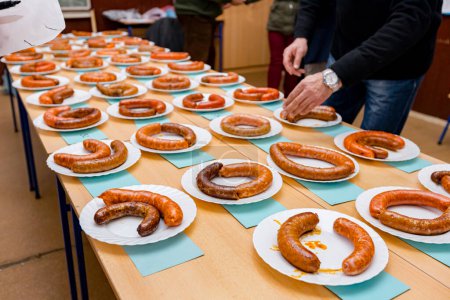 Photo for Traditional sausages are arranged for review at food contest. Judges will assess best sausages that are exposed on sausage tournament. - Royalty Free Image